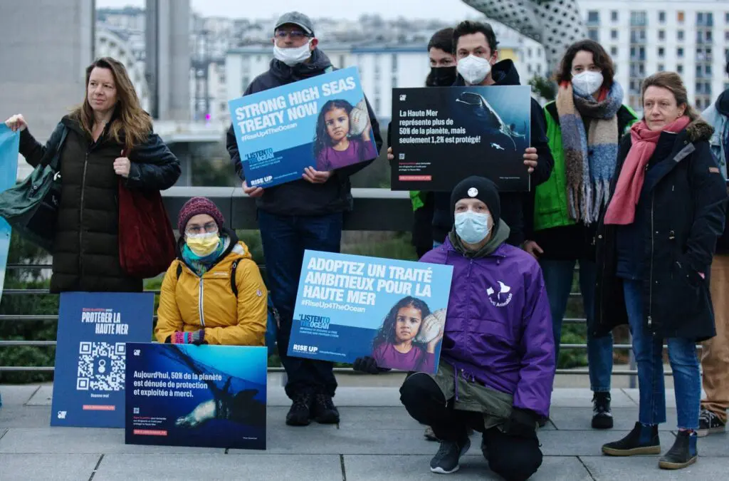 Group of activists holding ocean protection campaign signs