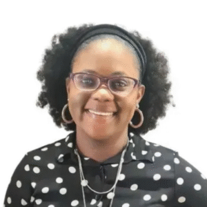 Headshot of a smiling woman wearing glasses and a black-and-white polka-dot top.