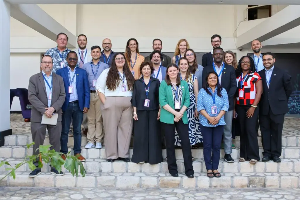 Large group of delegates posing for a photograph on outdoor steps
