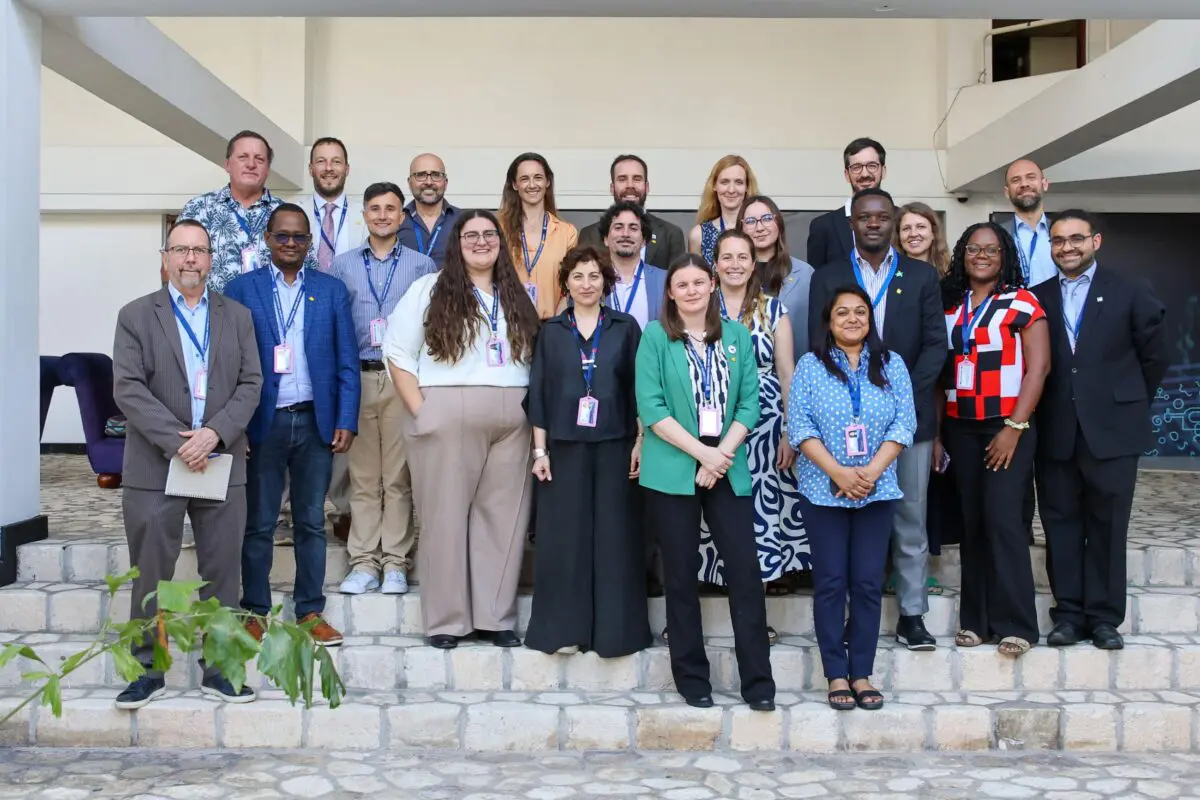 Large group of delegates posing for a photograph on outdoor steps