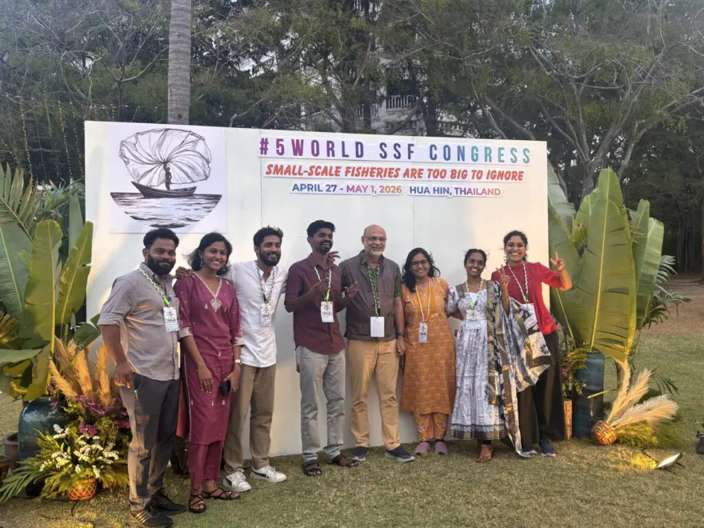 Group of delegates posing in front of a World Small-Scale Fisheries Congress backdrop